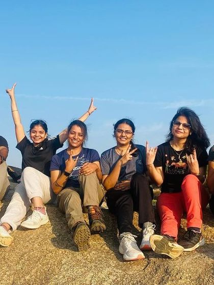 A happy group of trekkers posing on the rocky terrain of Antaragange.