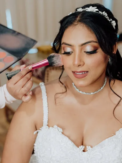 Applying a soft pink blush to add a healthy glow. This behind-the-scenes shot shows how I build color gradually for a natural, seamless finish.
