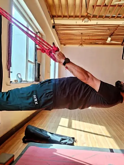 My own practice is my foundation. Here I am using wall ropes for a supported horizontal plank, a powerful core strengthening asana that requires dedication and focus. This is the kind of strength I help my students build.
