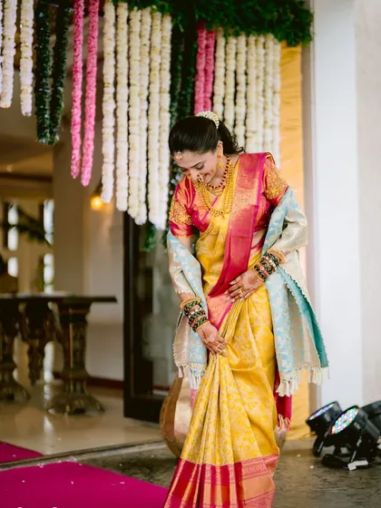 A candid shot of the bride adjusting her beautiful yellow Paithani saree. I love seeing my brides feel comfortable and happy in the looks we create together.