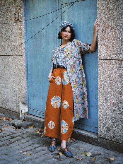Street style meets slow fashion. This look for House of Wandering Silk, shot against a simple blue door, shows how artisanal pieces can be effortlessly cool and contemporary.