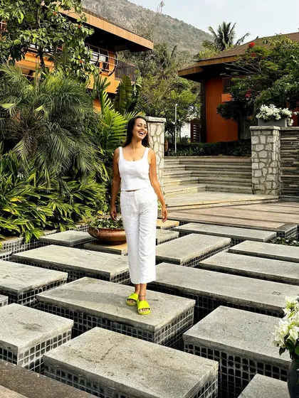 A guest enjoys the unique design of our water garden. The geometric stepping stones and lush greenery create a harmonious and visually stunning environment.