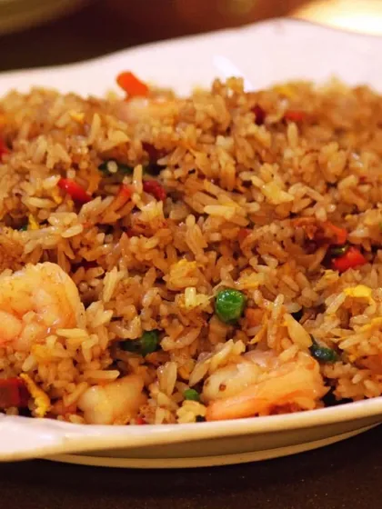 To cater to diverse tastes, our menu includes a variety of cuisines. This is a close-up of our flavorful prawn fried rice, a popular choice from our Asian menu selection.