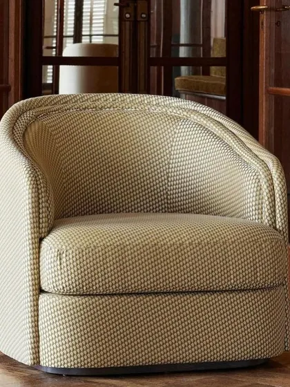 The 'Boromeo' armchair from Nobilis features a timeless, enveloping design. Its double-curved backrest, upholstered here in a sophisticated, small-scale geometric weave, gently cradles you in comfort and style.