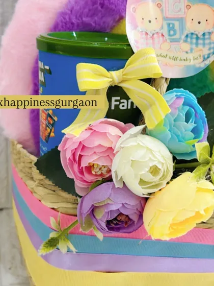 A close-up of the multi-colored flowers and treats inside the rainbow hamper, showing the care and detail I put into every arrangement.