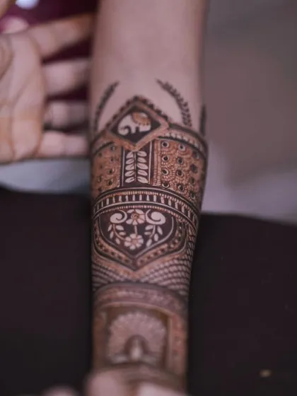 A side view of the forearm, giving a clear look at the elephant and floral band work. This demonstrates the precision in every part of the design.