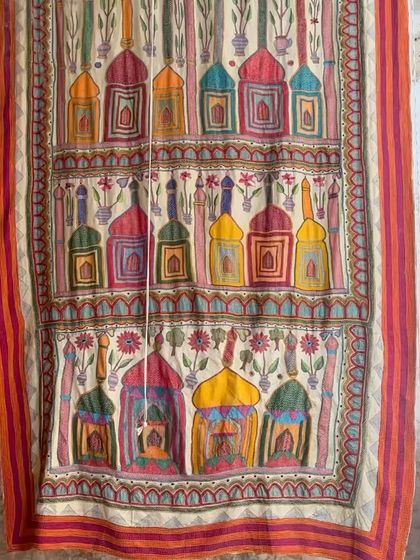 A vibrant, hand-painted textile panel displayed at one of our workshops. These large-format pieces can serve as stunning art for the home, showcasing the painterly quality of our craft.