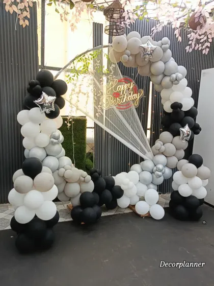 A clean, ground-level view of the monochrome balloon arrangement. The structure is built with varying balloon sizes to create texture and visual interest, resulting in a professional and polished look.