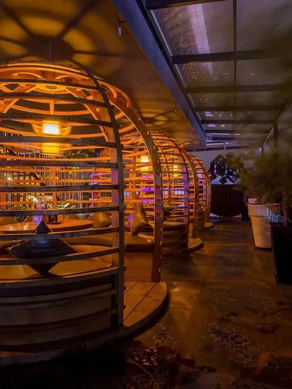 We designed these custom wooden booth seats to be cozy, private cocoons within the larger space. The warm lighting and unique spherical shape make them a favorite spot for guests to settle in for the evening.
