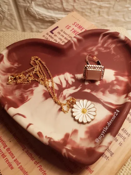 Our Aurora Heart Tray placed on a book, creating a cozy and aesthetic scene.