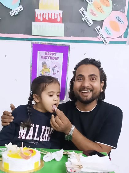 A happy moment between a therapist and a child during a birthday celebration. These positive interactions build strong, trusting relationships.