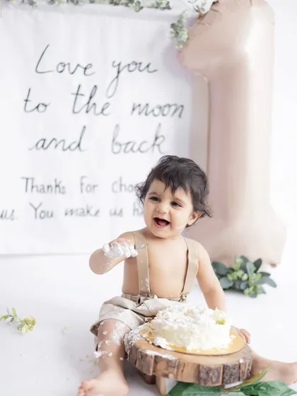 Let them eat cake! A first birthday cake smash is all about capturing pure, messy joy. This little one is having the time of his life during his minimalist-themed cake smash session at our studio.