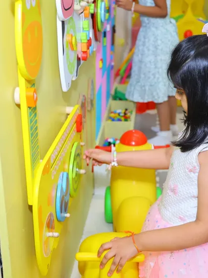 Our interactive wall is perfect for toddlers and young children to engage their senses. This little one is exploring different sounds and textures on our musical guitar panel.
