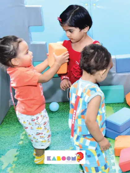 Even our littlest visitors have a blast! Here, toddlers are engaged in safe, creative play, stacking colorful soft blocks and learning through interaction in our dedicated play area.
