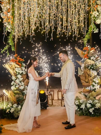 A magical moment of commitment under a canopy of fairy lights, punctuated by dazzling fireworks. This setup was designed for a dramatic and romantic ring exchange, creating an unforgettable memory for the couple and their guests.