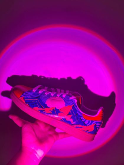The UV-reactive design glowing under a purple light. This pair is all about the experience.
