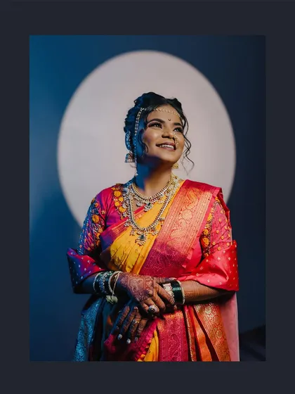 A beautiful bridal portrait using a spotlight to create a halo effect, highlighting her joyful expression and stunning attire.