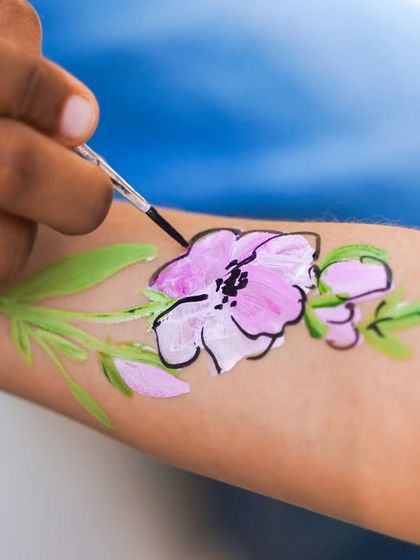 Our on-site artists provide beautiful face and arm painting, like this delicate floral design, to match the enchanting party theme.