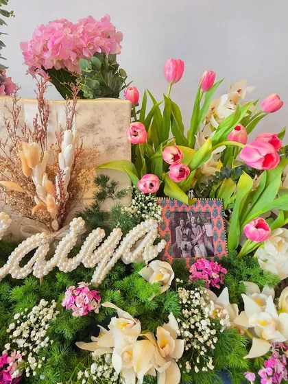 A detail shot of the personalized "Maiya" hamper, focusing on the pearl lettering and the framed photo, showing how I incorporate personal items into my designs.