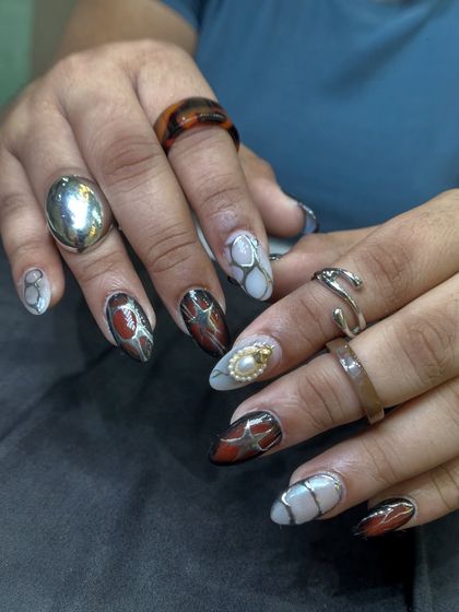 This set is a masterpiece of mixed media art, featuring abstract patterns, metallic accents, and 3D pearl details. It's a bold, artistic look for someone who isn't afraid to stand out.