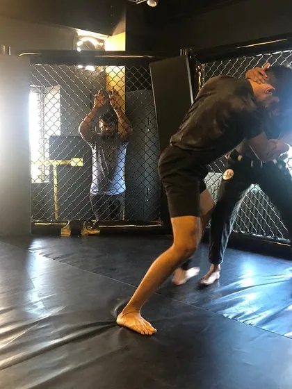 We use the cage to simulate real MMA scenarios. This shot from our BJJ Jam shows two members working on their wrestling and clinch game against the fence.