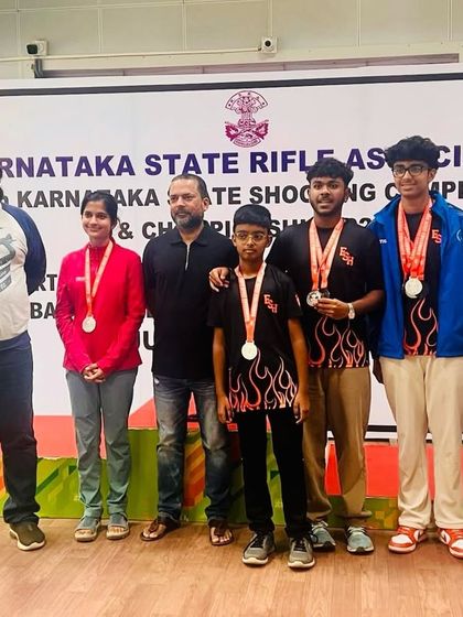 Our medal-winning team and coaches at the Karnataka State Shooting Championship. We believe in celebrating our collective successes as one strong unit.