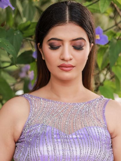 A designer shoot for a modern lavender lehenga. The images were taken in a lush garden, with the purple flowers complementing the color of the outfit, creating a soft and romantic fashion story.
