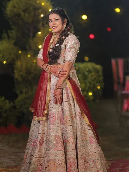For me, a bridal lehenga should be a masterpiece. This stunning white and red lehenga features intricate embroidery and a classic silhouette, designed to make my bride feel like royalty on her special day.