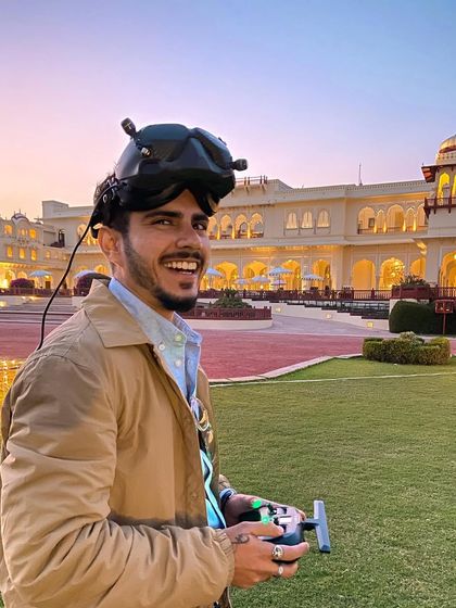 A happy shot of me at a palace hotel in Jaipur, smiling with my gear. This photo captures the joy of doing what I love in beautiful locations.