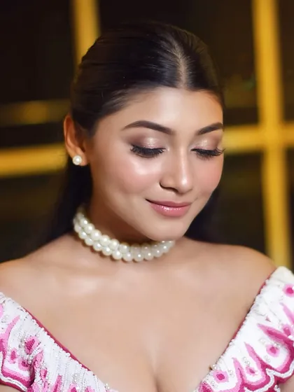 A close-up on the shimmery eye makeup and glossy lips. This look is all about shine and making our star feel her brightest.