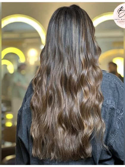 The back view of the ash blonde transformation, highlighting the dimension and shine.