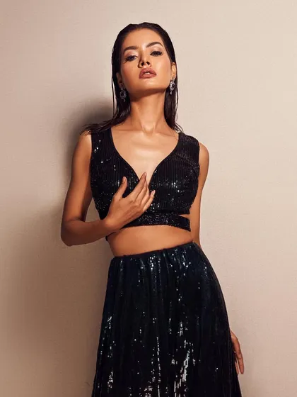 A fierce and modern look. The wet-look hair and sharp, graphic winged liner create a high-fashion vibe that's perfect for an editorial shoot.