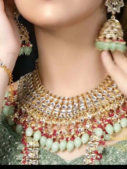 A close-up of a beautiful mint green and ruby Polki set. I can customize the bead colors to match your specific outfit requirements.