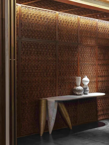 We believe in reviving heritage crafts within contemporary contexts. For this dining room, we commissioned intricate Pinjirakari lattice work, transforming the walls and ceiling into a jewel box that filters light and creates an atmosphere of intimate, handcrafted luxury.