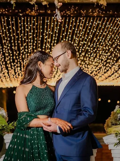 The couple shares a quiet moment under the enchanting fairy light installation.