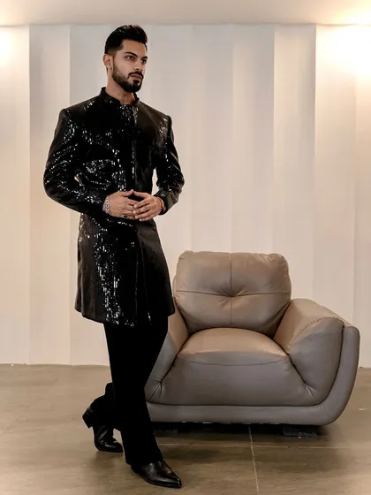 A modern statement for evening events. This black sequined Indo-Western jacket is tailored for a sharp, powerful silhouette, offering a glamorous and contemporary option for cocktail parties and wedding receptions.