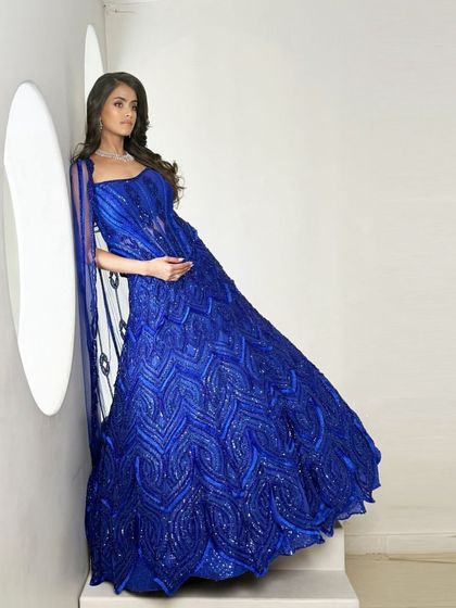 Bold, electric, and unforgettable. This electric blue bridal lehenga brings the drama with intricate, all-over embellishments and a flowing dupatta for a bride who dares to stand out.