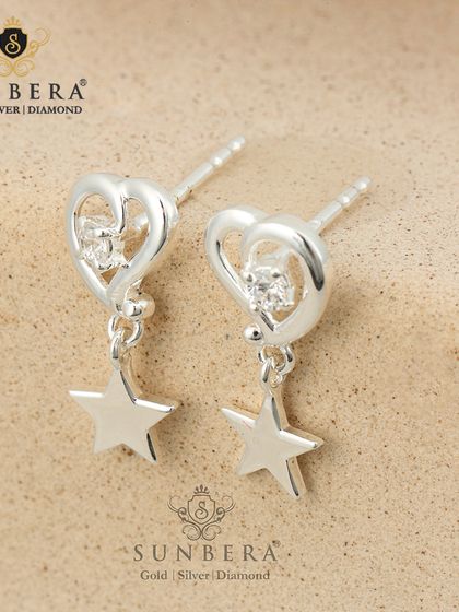 Silver drop earrings with a heart-shaped stud and a dangling star. This design combines romantic and celestial themes for a charming and shimmery effect.