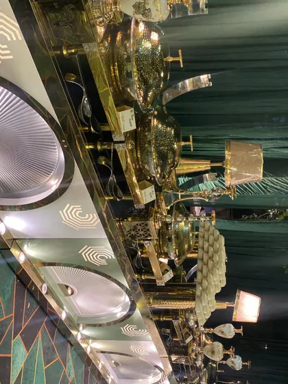 A detailed shot of our buffet counter at a dhol night in Pitampura. The display includes our signature brass serving dishes, stacks of traditional kulhads for serving, and elegant table lamps for ambiance.