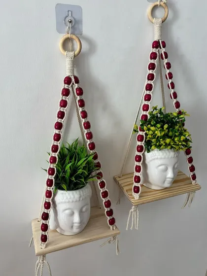 Another perspective of the pink beaded planter shelves, highlighting their simple yet elegant design.