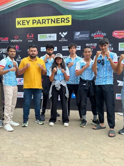 The full team posing with their coaches at the MMA National Championship in Mumbai.