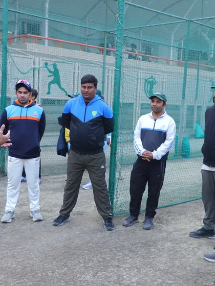 Our coaches in discussion with Ajay Ratra. We constantly engage with professionals at the top of the sport to ensure our training methods remain at the cutting edge of cricket development.