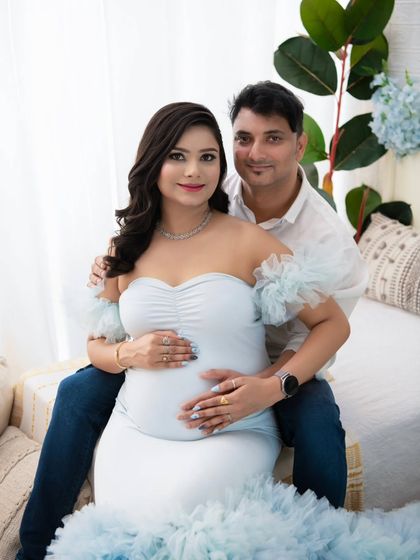 A lovely portrait of the couple seated together, looking directly at the camera. Their relaxed smiles and comfortable embrace show the easy love they share.