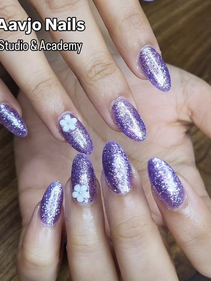 A full view of the almond-shaped lavender glitter nails. This is a perfect choice for parties, weddings, or any time you want to feel glamorous.
