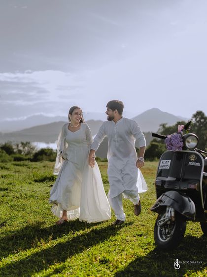A dynamic shot of the couple running and laughing, with the scooter as a key element in the frame.