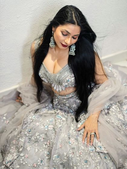 A closer look at the detailed craftsmanship on the blouse and lehenga worn by Tanishaa Mukerji. The silver thread work and sequin embellishments catch the light beautifully.