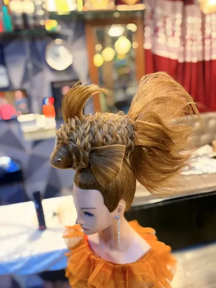 The completed fish hairstyle from the side. The entire structure, from the body to the fins and tail, is crafted from hair.