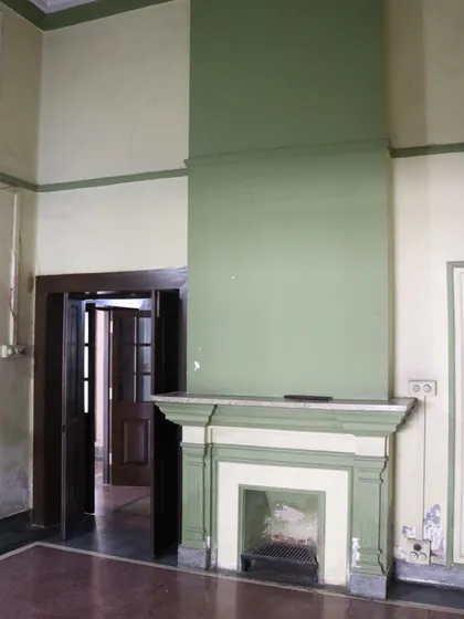 Another fireplace in the house, this one with a distinct color scheme, showcasing the variety of original details we encounter and restore.