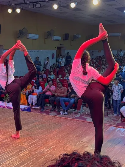 A glimpse into one of our choreographed stage performances. The synchronization and advanced asanas, like this standing bow pose, create a powerful visual spectacle that makes any event unforgettable.