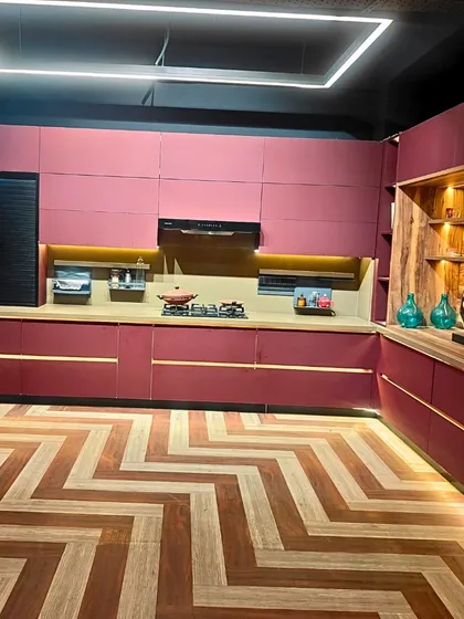 We believe your home should reflect your personality. This bold, contemporary kitchen design features a striking color palette, chevron-patterned flooring, and integrated lighting, proving that functional spaces can also be stunning works of art.